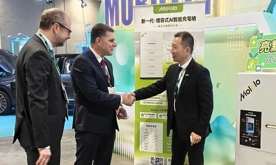 Syneric and partners shaking hands in front of the Mololo banner at MIECF